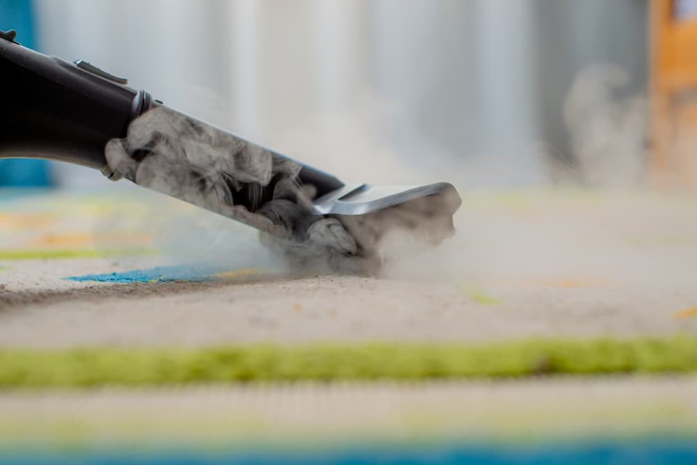 Steam cleaning a synthetic rug